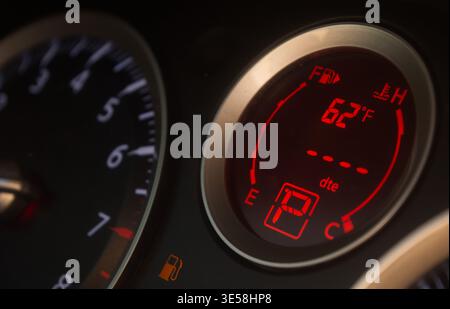 Stranded on the side of the road with no gas in the tank due to fuel shortage and high prices brought upon by the war overseas. Odometer reads empty. Stock Photo