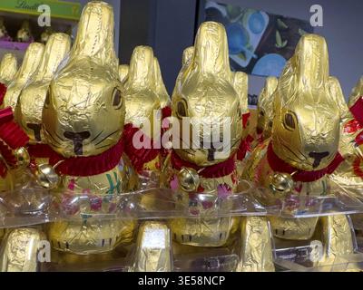 Display on shelf of retail wholesale of chocolate Easter bunnies chocolate Easter bunnies Easter bunnies made of chocolate brand Lindt wrapped in gold Stock Photo