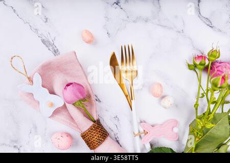 Easter Table Design with Pink Decor and Gold Cutlery Stock Photo