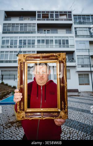 Faro, Portugal -  March 10, 2026: Portrait of adult man with Down syndrome in front of a residential neighborhood Stock Photo