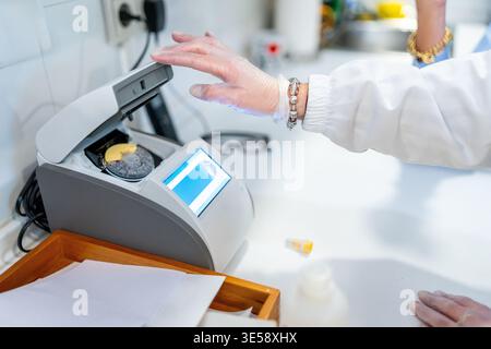 Pharmacist conducting medical analysis using laboratory equipment Stock Photo