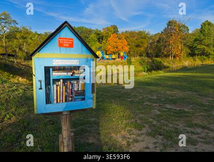 A Little Free Library book exchange box stands at the edge of a city park in Twinsburg. Little Free Library has over 200,000 book boxes in the world. Stock Photo