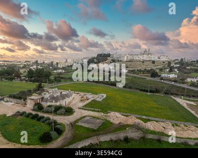 Scenic Locorotondo at Golden Hour – Circular White Town on Puglia Hilltop – Iconic Italian Village with Flower-Lined Alleys – Trulli houses Stock Photo