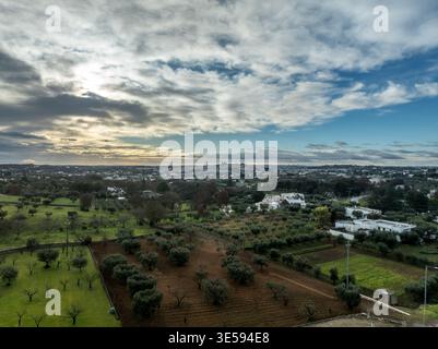 Scenic Locorotondo at Golden Hour – Circular White Town on Puglia Hilltop – Iconic Italian Village with Flower-Lined Alleys – Trulli houses Stock Photo