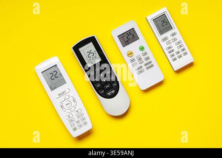Air conditioner remote controls on yellow background Stock Photo