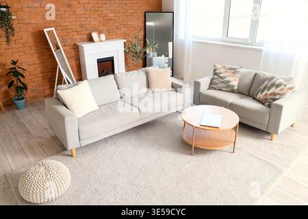 Interior of living room with sofas, fireplace and mirrors Stock Photo