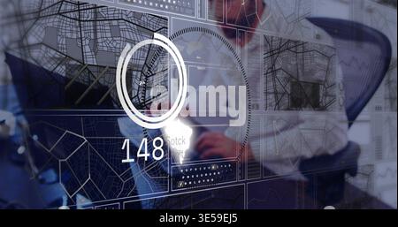 Studying male worker in dress shirt and tie interacting with tablet at office desk, HUD 148 Stock Photo