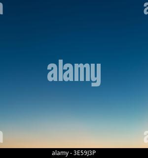 Photo of a beautiful clear evening sky without clouds. Sky gradient from orange to blue. Stock Photo