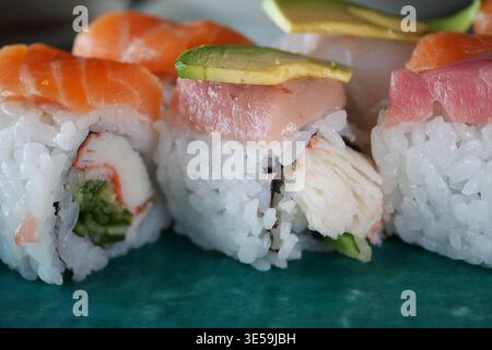 Sushi rolls with fresh fish and avocado on a plate Stock Photo