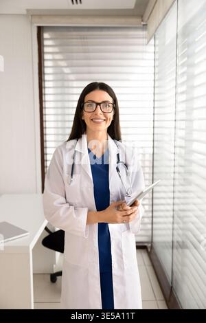 Female doctor holding digital tablet posing for professional portrait Stock Photo