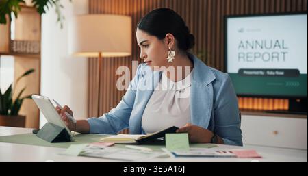 Notebook, woman and reading tablet in office for stock price info, data comparison and forecasting. Financial analyst, tech and budget review at desk Stock Photo