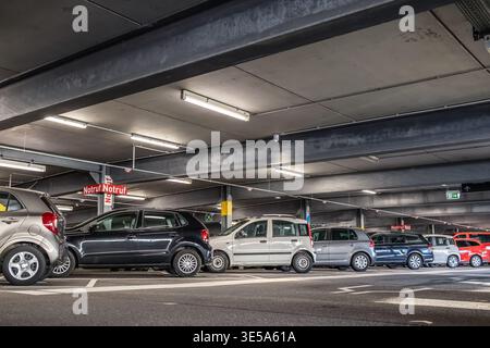 Parking garage - interior shot of multi-story car park, underground parking with cars Stock Photo
