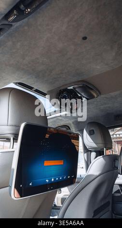 Smart display and dashboard in modern car interior with clear sky in background Stock Photo
