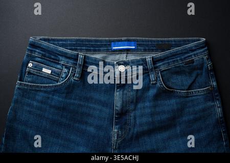 Blue jeans isolated on dark background representing casual fashion style Stock Photo