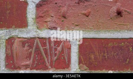 Brick wall, letter and cement with writing on concrete building structure for memory or imprint. Empty, space and construction with rectangle blocks Stock Photo