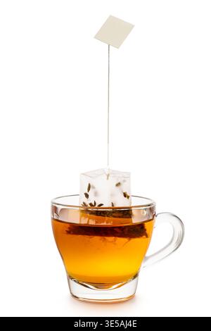 Glass cup of tea with tea bag inside, isolated on white background. Stock Photo