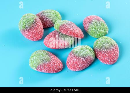 Strawberry candies on blue background Stock Photo