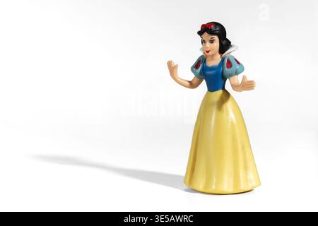 Milan, Lombardy, Italy- February 04, 2026: Snow White character figurine standing on a white background creating a shadow Stock Photo