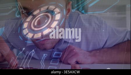 Leaning male in light collared shirt inspecting keyboard at workstation, with circular HUD overlays Stock Photo