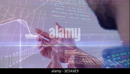 Holding adult hands scrolling smartphone screen in office, displaying financial charts and tickers Stock Photo