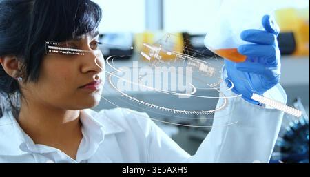 Examining researcher in white coat and blue gloves holding conical flask in lab, with hologram Stock Photo