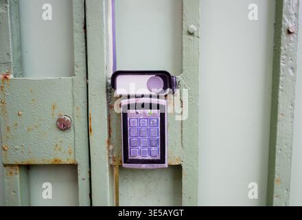 Electronic keypad access control system on metal gate with security code lock and modern entry protection concept Stock Photo