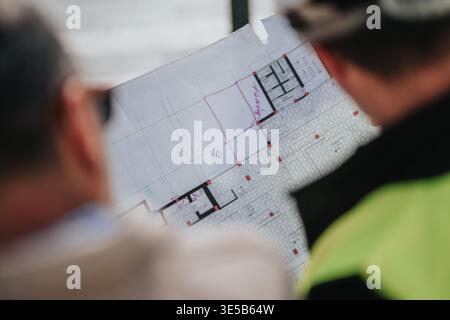 Furing Layout Pln Reviewing architectural floor plans and technical drawings during a ...