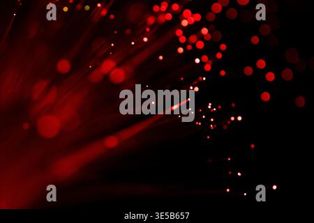 Abstract red glowing bokeh lights scattered on a dark background, representing digital data, cyber security, and futuristic technology concepts. Stock Photo