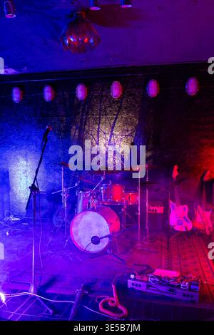 Band instruments waiting on a dimly lit stage creating an atmosphere for a musical performance Stock Photo