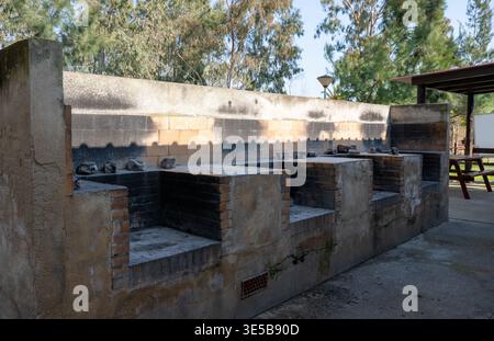 Outdoor barbecue grill station with brick fire pits in campsite park rustic cooking area travel and leisure concept Stock Photo