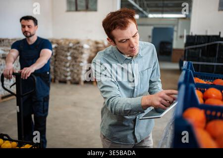 Quality control manager using digital tablet checking freshness Stock Photo