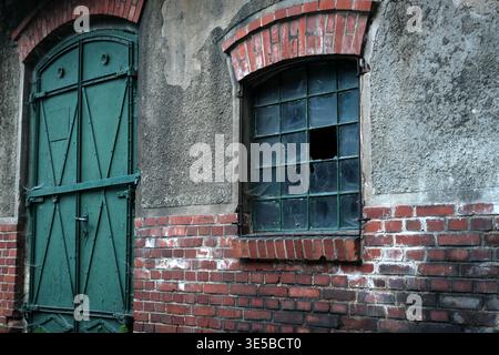 Old Brick Facade. Dilapidated Brick Wall With Arched Lintel And Moody Overcast Lighting In Urban Setting Stock Photo