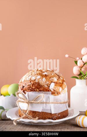 Traditional Easter bread or cake paska or panettone with festive Easter decoration and pastel colored eggs Stock Photo