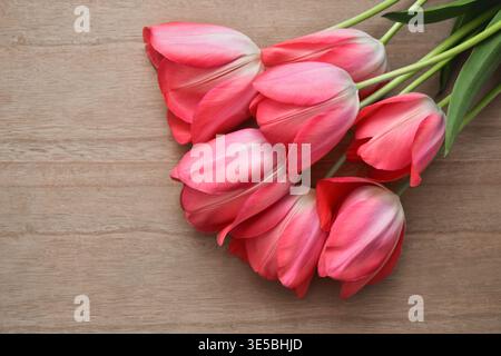Bouquet of fresh pink tulips on a wooden table closeup Stock Photo
