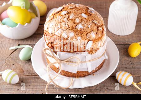 Traditional Easter bread or cake paska or panettone with festive Easter decoration and pastel colored eggs Stock Photo