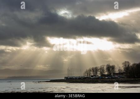 Rays of light breaking through winter clouds Dalgety Bay, Fife, Scotland Stock Photo