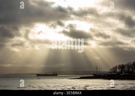 Rays of light breaking through winter clouds Dalgety Bay, Fife, Scotland Stock Photo
