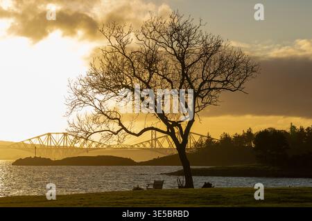 A beautiful sunset over the Forth Bridge with Downing Point in the foreground, Dalgety Bay, Fife. Stock Photo