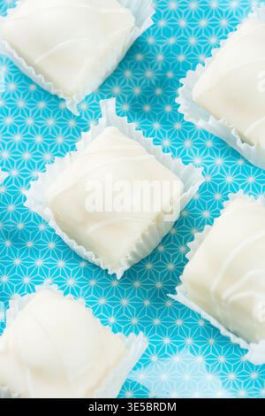 Mr Kipling Frosty Fancies on a blue plate. Stock Photo