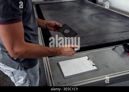 Male engineer setup plasma cutter for work in metalwork workshop. Stock Photo