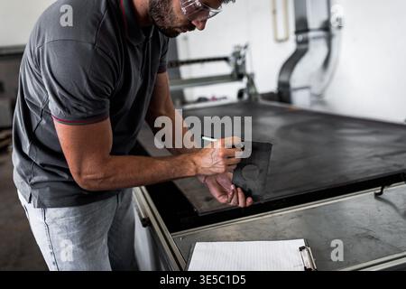 Male engineer setup plasma cutter for work in metalwork workshop. Stock Photo