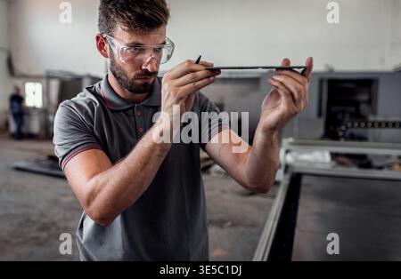 Male engineer setup plasma cutter for work in metalwork workshop. Stock Photo