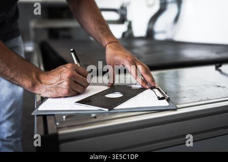 Male engineer setup plasma cutter for work in metalwork workshop. Stock Photo