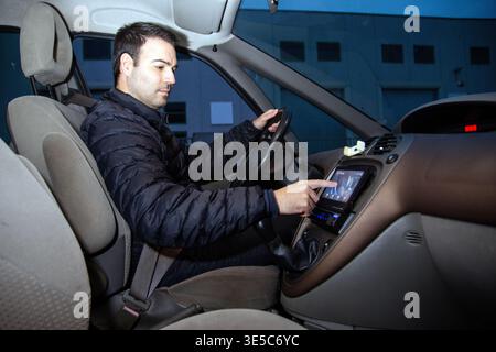 Driver using car navigation system while driving Stock Photo