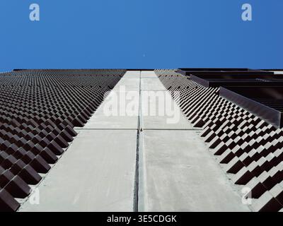 Modern building facade with geometric dark metal cladding and concrete panels viewed from below, Tallinn, Estonia Stock Photo