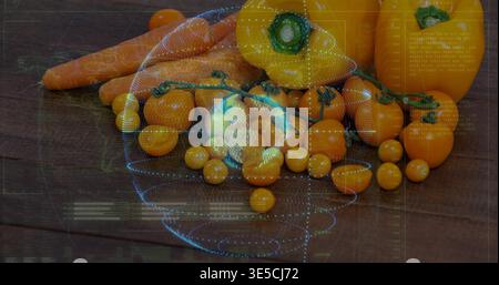 Displaying cluster of cherry tomatoes, yellow peppers, carrots on dark table, with blue overlay Stock Photo
