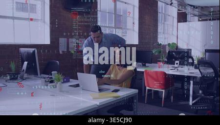 Leaning male in blue-shirt reviewing code with female in yellow-tee at loft office, silver laptop Stock Photo