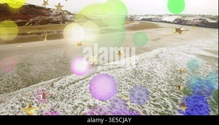 Crashing waves forming foam line over wet sand at aerial view, with colored bokeh, gold stars Stock Photo