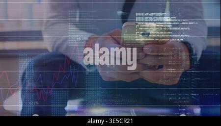 Holding smartphone, man in dark suit analyzing red blue market charts and code overlays in lobby Stock Photo