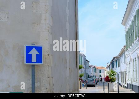A street signpost arrow in bright sunlight in a French village Stock Photo